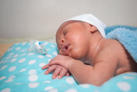 Newborn baby boy sleeping on a blue blanket. Shallow depth of fieldの写真素材