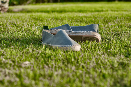 Close up of shoes on green grass with shallow depth of field.の写真素材