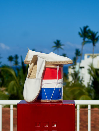 White sandals on a red box on a background of palm treesの写真素材