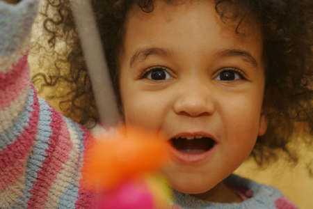 A beautiful mixed race girlelated at winning a gameの写真素材