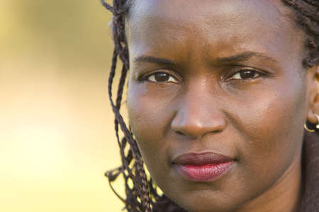 Close up of a beautiful black woman with a thoughtful look on her faceの写真素材
