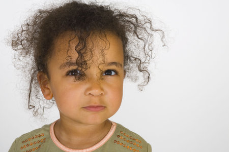 A beautiful mixed race girl making an angry face.