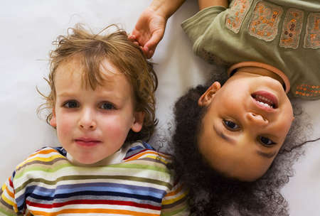 A beautiful mixed race girl and her blond cousin having funの写真素材