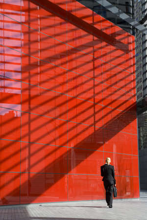 A young blonde businesswoman walking through a hi tech landscapeの写真素材
