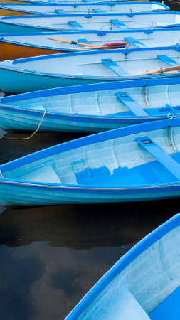 A row of blue rowing boatsの写真素材