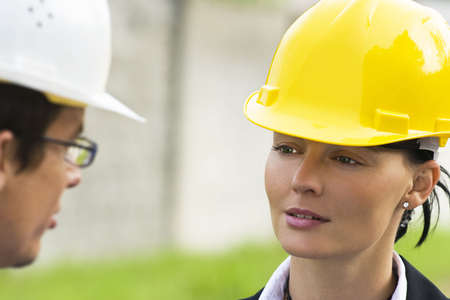Young male and female managers working together in an industrial situation の写真素材