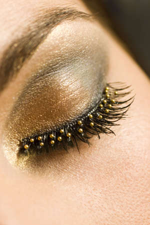 A macro close up of a beautiful woman's made up eye with false eyelashesの写真素材