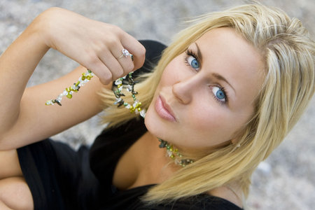 Portrait of a sexy and beautiful young blond woman sitting at the beach の写真素材