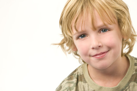 Studio shot of a young blonde boy with a happy smile