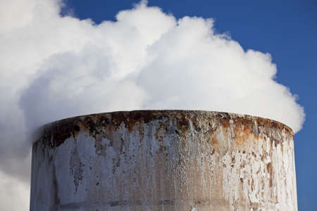 Close up shot of steam coming from the top of a chimney. Shot on location at a geothermal power station in Iceland.の写真素材