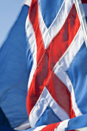 A slow shutter speed shot of the Icelandic flag with deliberate motion blurの写真素材