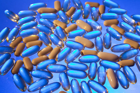 Stylised studio shot of back lit medicine tablets pills drugs and capsules