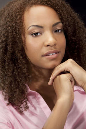 A beautiful miced race African American girl laying down with perfect teeth and smileの写真素材