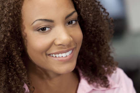 A beautiful mixed race African American girl with perfect teeth and smileの写真素材