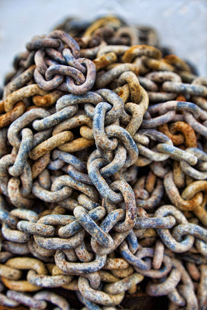 HDR photograph of a pile of old textured and rusty chains, macro shot with a narrow depth of field.