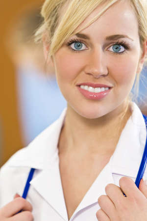 A pretty young female blond haired blue eyed nurse with a stethoscope の写真素材