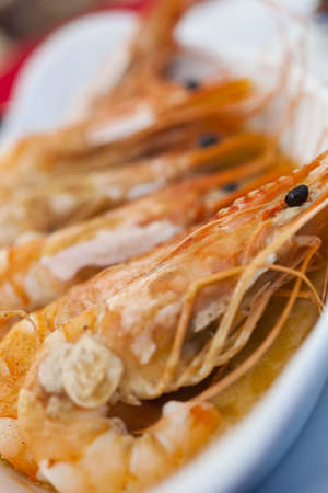 A dish of giant prawns or shrimps cooked in garlic butter, shot on location in a French seafood restaurant in Normandy, France, Europeの写真素材