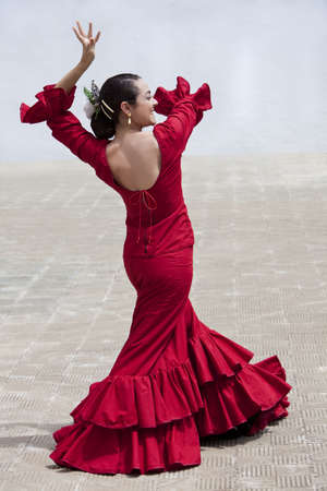 Woman traditional Spanish Flamenco dancer dancing in a red dress の写真素材