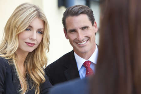 A beautiful businesswoman in a meeting with her male and female colleaguesの写真素材
