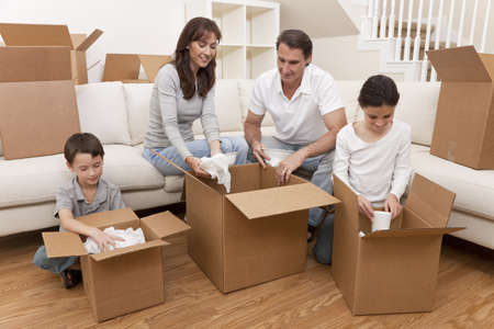 Family, parents, son and daughter, unpacking boxes and moving into a new home.の写真素材