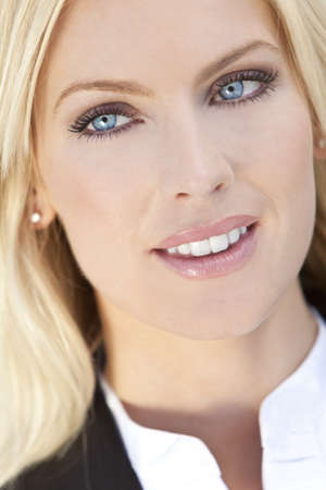 Natural light portrait of a beautiful blond woman with blue eyesの写真素材