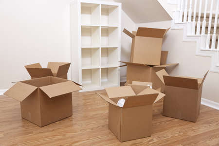 Empty room full of cardboard boxes for moving into a new home.の写真素材