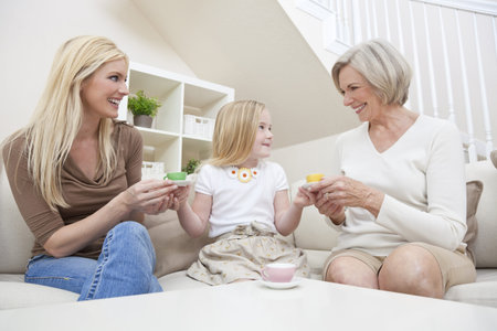 Three female generations of one family at home. Mother, grandmother and daughter who is playing at...
