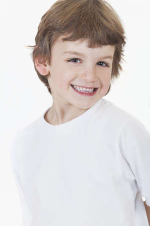 White background studio photograph of young happy boy smilingの写真素材