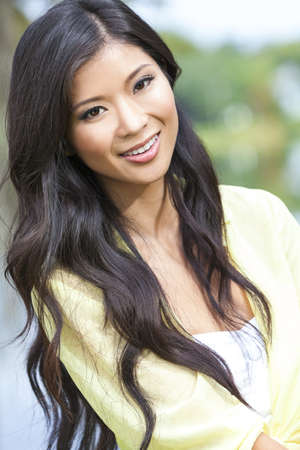 Outdoor portrait of a beautiful young Chinese Asian young woman or girlの写真素材