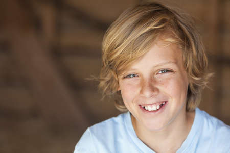 Young happy smiling blond boy child aged about 12 or early teenager  の写真素材