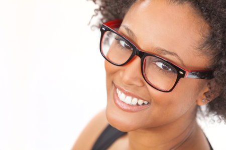 A beautiful intelligent mixed race African American girl or young woman looking happy and wearing...