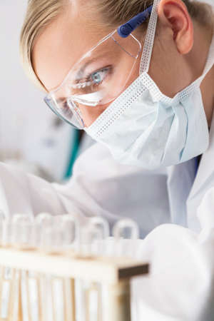 A blond medical or scientific researcher or doctor working in a laboratory の写真素材