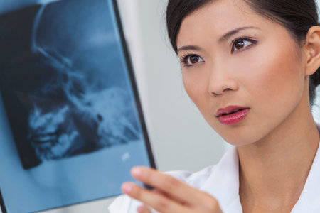 A Chinese Asian female medical doctor with head skull x-ray in a hospital