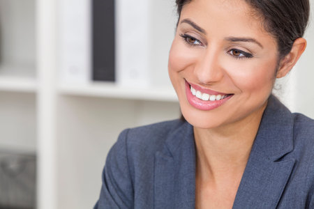 Portrait of a successful beautiful young Latina Hispanic woman or businesswoman in her office...