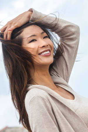 Outdoor portrait of a beautiful young Chinese Asian young woman or girlの写真素材