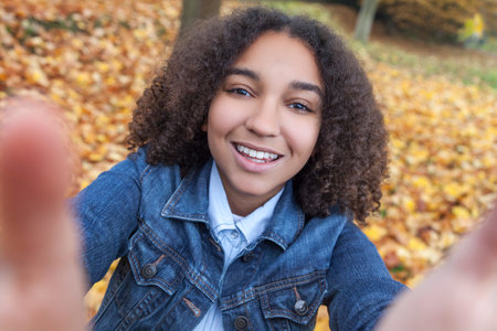 Beautiful happy mixed race African American girl teenager female child smiling with perfect teeth...
