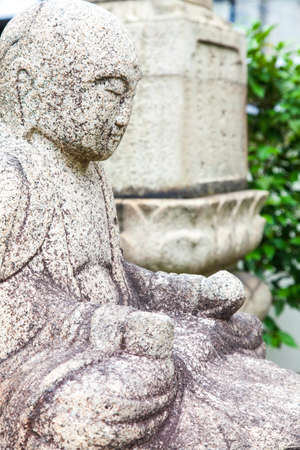 Carved Buddha statue at an Asian Buddhist Templeの写真素材
