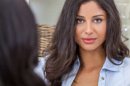 Portrait of a beautiful thoughtful young Latina Hispanic woman with a friendの写真素材