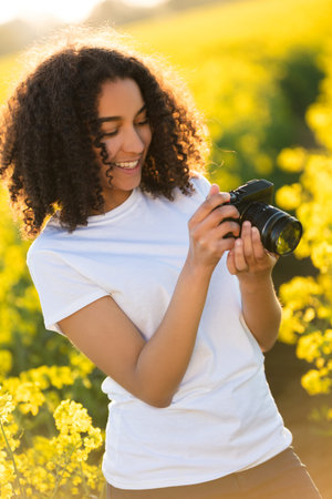 Beautiful happy mixed race African American girl teenager female young woman smiling outdoors in...