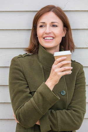 Portrait shot of an attractive, successful and happy middle aged woman female outside smiling...