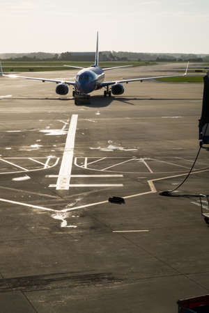 A modern commercial airplane or airliner on the runway at an airport taxiing to the passsenger gateの写真素材