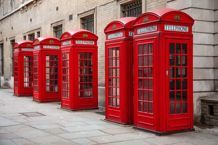 Row of five classic traditional red telephone boxes, London, Englandの写真素材