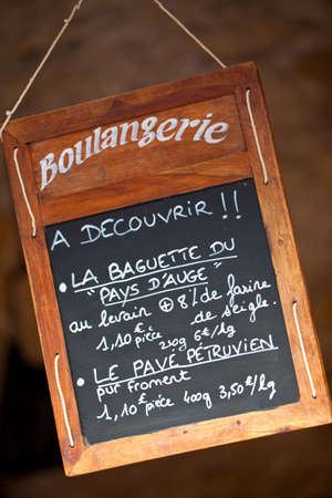 Wooden blackboard or chalkboard sign in the Window of French Boulangerie or Bakers in France, Europeの写真素材