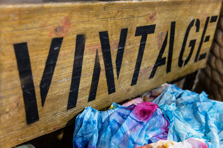 Wooden sign advertising vintage clothing for sale in shop or on market stall