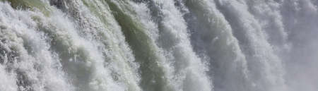 Panoramic close up of white water going over a waterfall, panorama background web banner banner, header, panoramic, background, header.の写真素材