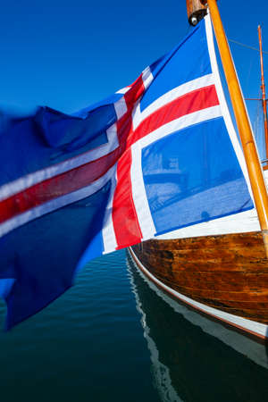 Icelandic flag and traditional wooden boat, Reykjavik Harbor, Icelandの写真素材