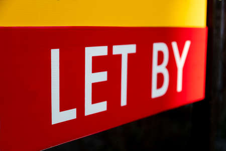 Close up on red Let By rental real estate agents sign or boardの写真素材