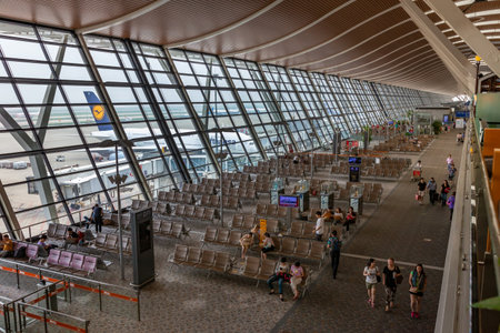 PASSENGERS WAITING SHANGHAI PUDONG INTERNATIONAL AIRPORT, JULY 12 2014, Seating area departure gates airside and Lufthansa airplane, Shanghai Pudong International Airport, Peoples Republic of China, Asiaのeditorial素材