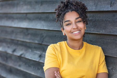 Girl teenager teen female young African American mixed race biracial woman outside smiling with perfect teethの写真素材