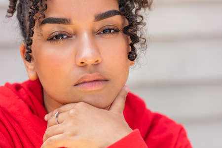Portrait of a thoughtful black mixed race biracial African American female young woman girl teenager teen outsideの写真素材